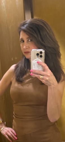 Customer posing in the brown Faux Suede Ruched Sleeveless Top with a hand on their hip.