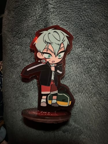 Customer's cute Alien Stage acrylic stamp of Till, shown assembled and standing on its red base.