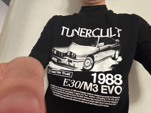 Customer's close-up of a black long-sleeved shirt from the Mystery Cash Box, featuring a '1988 E30/M3 EVO' car graphic.