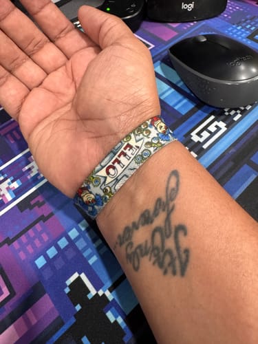 Close-up of the Take Nothing For Granted Labyrinth Bracelet on a reviewer's wrist, showing the colorful "'ELLO" design.