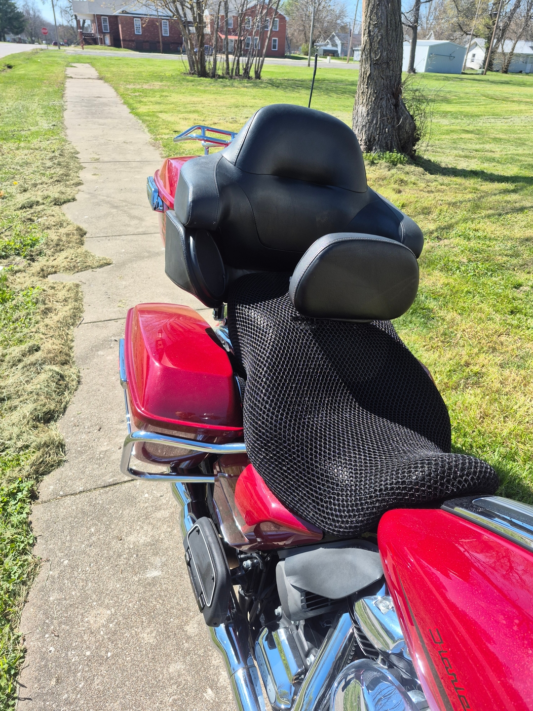 Road Glide with Wind Rider 3D mesh seat cover installed, rear three-quarter view of a touring Harley in daylight