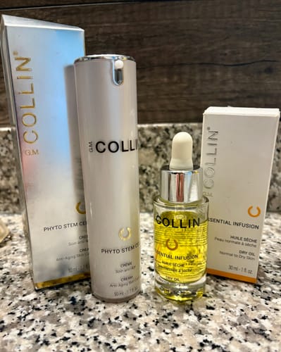 Customer's GM Collin Essential Infusion Dry Oil bottle and box, placed next to another skincare product.