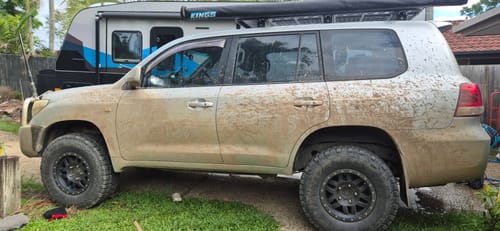 Reviewer's muddy silver 4WD parked in a driveway before being washed.