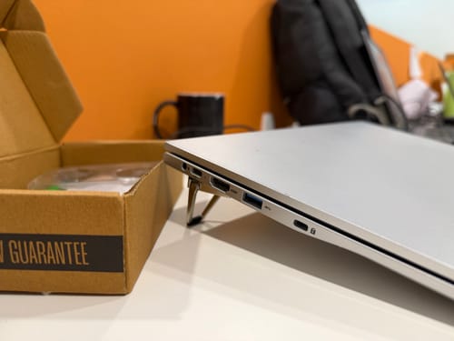 Customer's compact Casence AirStand attached to a silver laptop, elevating it on a desk.