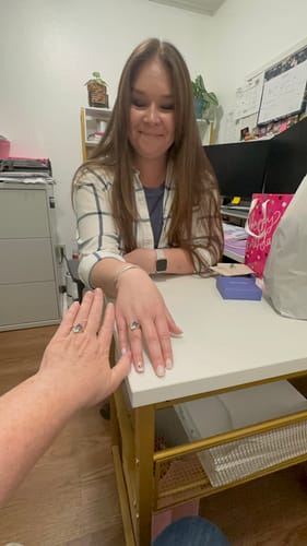 Customer and her daughter showing off their beautiful Navae Birthstone Rings at a desk.
