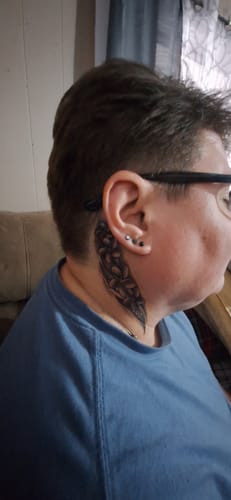 Reviewer shows a fresh black and grey tattoo on their neck, which they got using the Painless Tattoo kit.