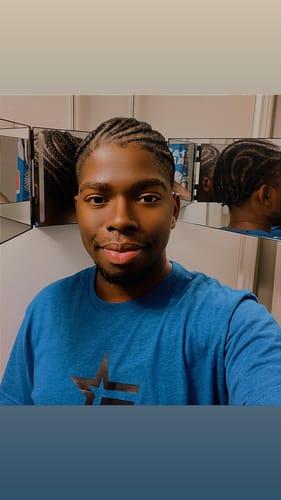Reviewer wearing the blue Freedom Formula Tee in a mirror selfie.
