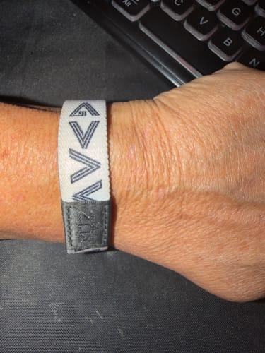 Customer wearing the fabric God Is Greater Bible Verse Bracelet on their wrist, with a keyboard in the background.