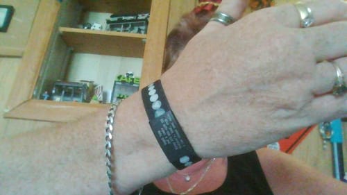 Close-up: Customer wearing the black It Works If You Work It Bracelet on their wrist.