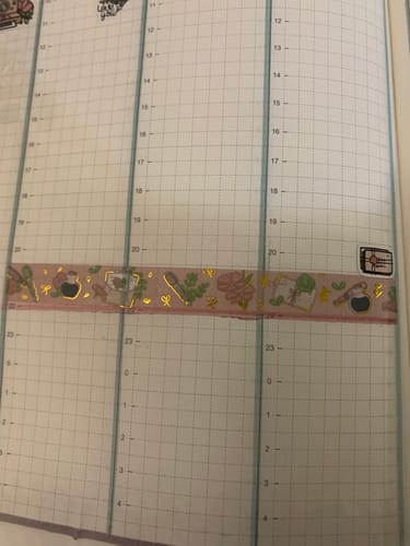 Customer's Vintage Stationery washi tape with shiny gold foil accents on a gridded planner page.