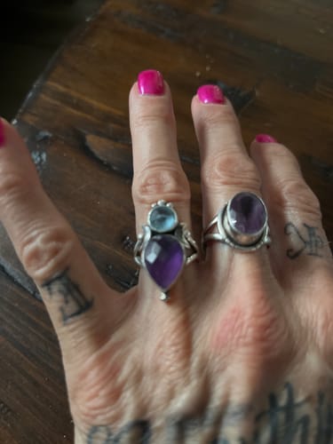 Customer showing the Aquamarine & Amethyst ring on their hand next to another gemstone ring.
