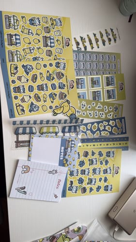 Reviewer's photo of the Sticker Subscription, showing various sticker sheets and stationery from the 'Blueberry Lemonade' theme.