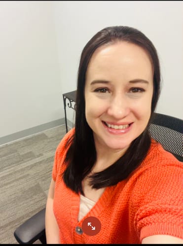 Reviewer smiling while wearing the coral, short-sleeved Beautiful Things Button Front Cardigan.