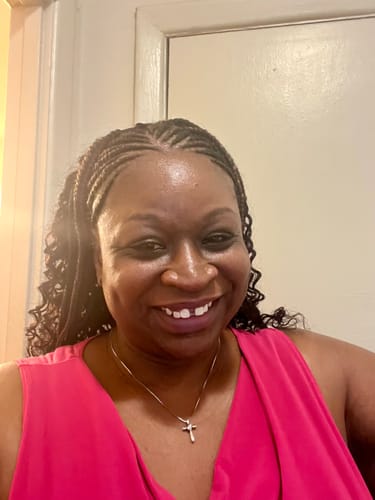 A customer smiles, showing their radiant skin after using the Brighten and Glow Serum.