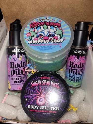 Customer's Sugar Spun Webs Body Butter in a black tub, shown with other skincare products from their order.