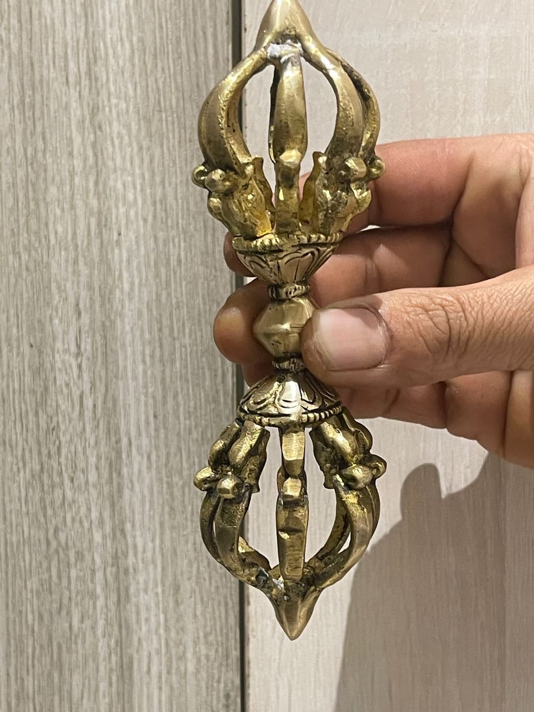 Customer photo review of Brass Vajra Dorje Ritual Tool Vastu Remedy for Protection, Tibetan Meditation and Home Temple Energy 15.7 x 4 cm | 340 gm