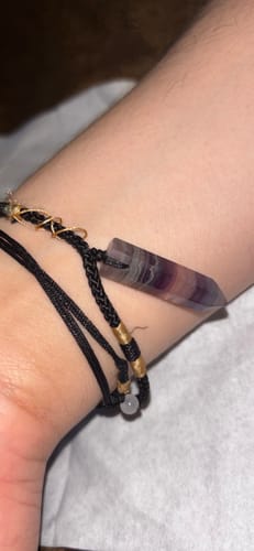 Close-up of a customer wearing the Natural Fluorite Necklace wrapped as a bracelet on their wrist.