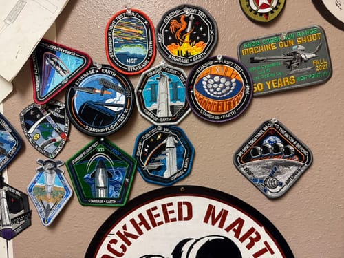 Customer's Artemis II - Collectors Patch pinned to a wall among a collection of other space-themed patches.