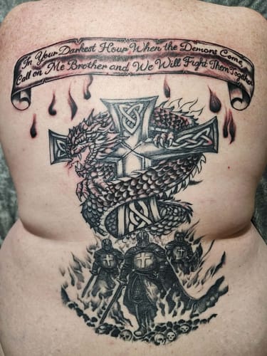 Customer shows a large, detailed back tattoo of a dragon and knights after using the Painless All-Stars Kit.