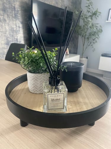 Customer's Istanbul Reed Diffuser on a decorative tray with a small plant and candle in their home.