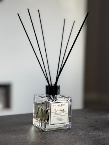 Customer's Istanbul Reed Diffuser in a clear, square bottle with black reeds on a dark surface.