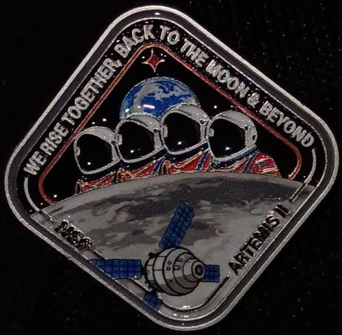 Customer's close-up of the Artemis II Collectors Pin, showing the detailed design against a black background.
