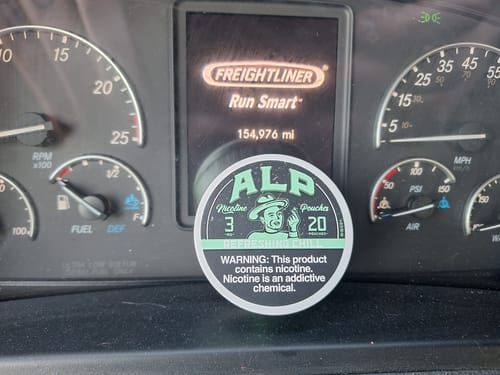 Customer's can of Refreshing Chill Nicotine Pouches resting on the dashboard of a truck.