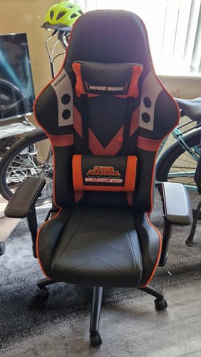 Customer's assembled My Hero Academia gaming chair in black and orange, with neck and lumbar support cushions.