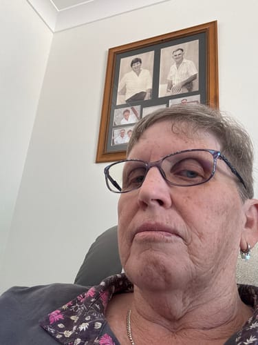 Reviewer wearing the Bullion Gold Boho Medallion Huggie White Gold Earring in a close-up photo.