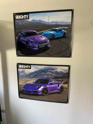 Customer's two 80Eighty car posters from the limited edition set hanging on a wall.
