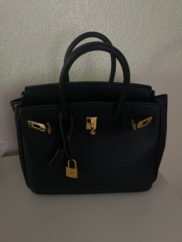 Customer's black pebbled Warkin Bag with gold hardware, shown sitting upright on a flat surface.