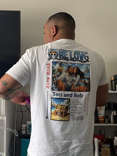 Kunde zeigt die Rückseite seines weißen ONE LOVE T-Shirts mit großem, personalisiertem Foto-Aufdruck.