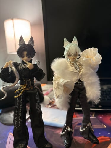 Reviewer's two The Past In Sicily MJD action figures, one in black and one in white, posed on a desk.