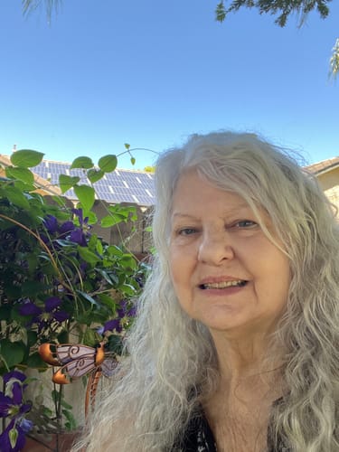 Reviewer with healthy skin smiles outdoors after using Koriderm™ Time Reverse Cream.