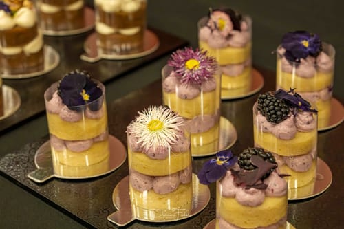 Reviewer's PRESSED DAISIES used to decorate small layered cakes in clear cups.
