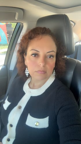 Customer showing a front view of the black Ronan Contrast Cardigan while sitting in a car.