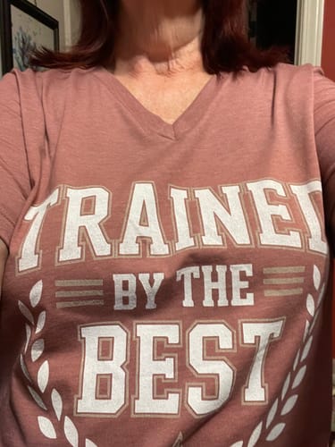 Reviewer wearing the heather-pink Trained By The Best V-Neck t-shirt.