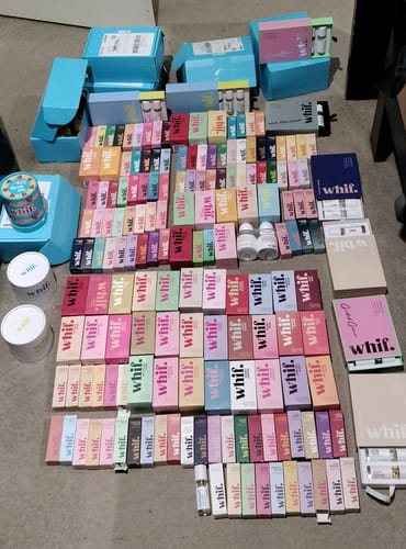 Customer's large haul of products, showing dozens of colorful whif fragrance boxes and vials spread across the floor.