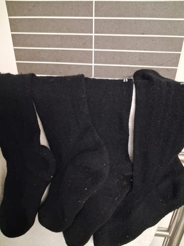 Customer's two pairs of black Crew Socks hanging to dry, showing light pilling.