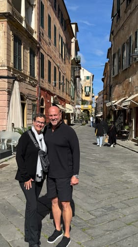 Reviewer wearing the black Zoey Zip Up Hoodie while standing on a European street.