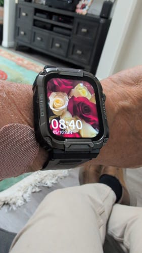 Customer's wrist with the rugged Gard Pro Ultra watch, showing a floral design on the digital screen.