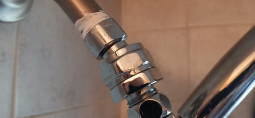 Customer's installed chrome Shower Head Swivel Adapter connecting the shower arm to the shower head.