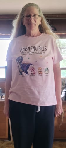 Customer wearing the pink personalized Grandmasaurus shirt with a 'Babasaurus' and kids dinosaur graphic.