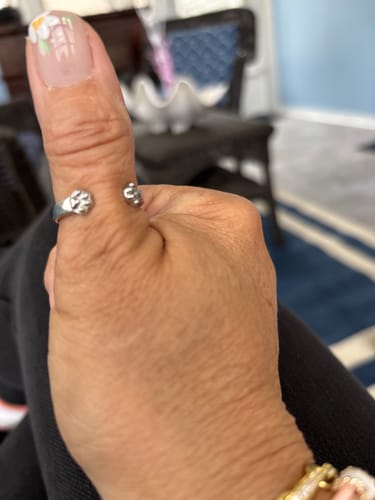 Customer's hand wearing the silver Paw Hug Ring on the thumb, giving a thumbs-up.