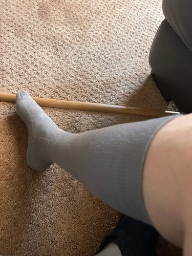 Customer wearing a grey Eucalyptus Lyocell Compression Sock on their leg.