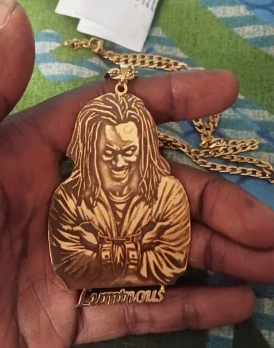 Customer holding their gold-colored Custom Photo Engraved Pendant Necklace with a detailed logo.