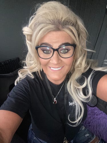 Customer with glasses smiling, showing her bright white Add Arch for Reward Spare Veneers.