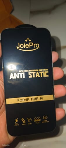 Reviewer holding the packaging for a Joie Pro anti-static screen protector.