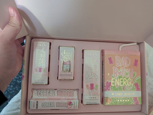 Customer holding open the pink What A Treat! Candy Bears box, showing the skincare and lip products inside.