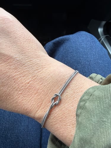 Customer wearing the silver Forever Knot Bracelet on their wrist.
